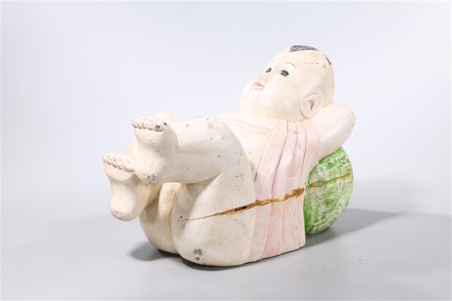 Appraisal: Chinese carved wood sculpture of a recumbent child x x