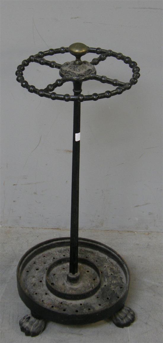 Appraisal: th century cast iron and brass stick stand raised on