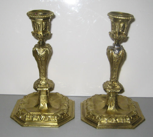 Appraisal: PAIR OF ANTIQUE CAST BRASS CANDLESTICKS Regency style low relief