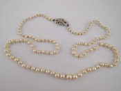 Appraisal: A graduated cultured pearl necklace with a diamond set clasp