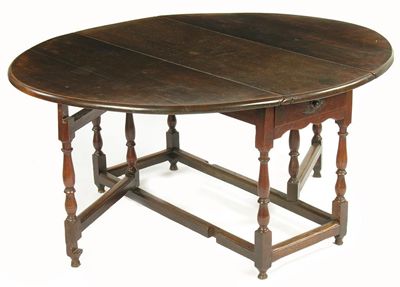 Appraisal: An oak gateleg table the oval top above an end