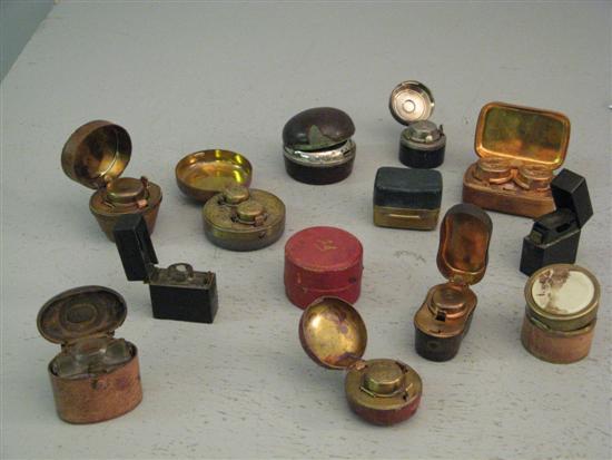 Appraisal: Twelve leather covered travelling inkwells and a vesta case