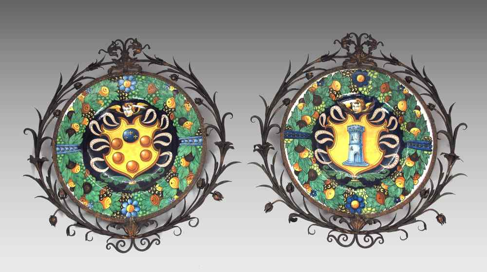 Appraisal: TWO IRON FRAMED FAIENCE CHARGERS Handpainted each with an angel