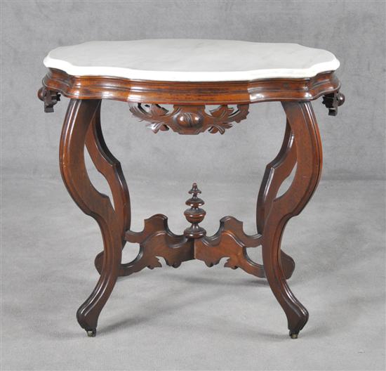 Appraisal: Victorian Walnut Turtle Top Center Table Circa Elaborately carved apron