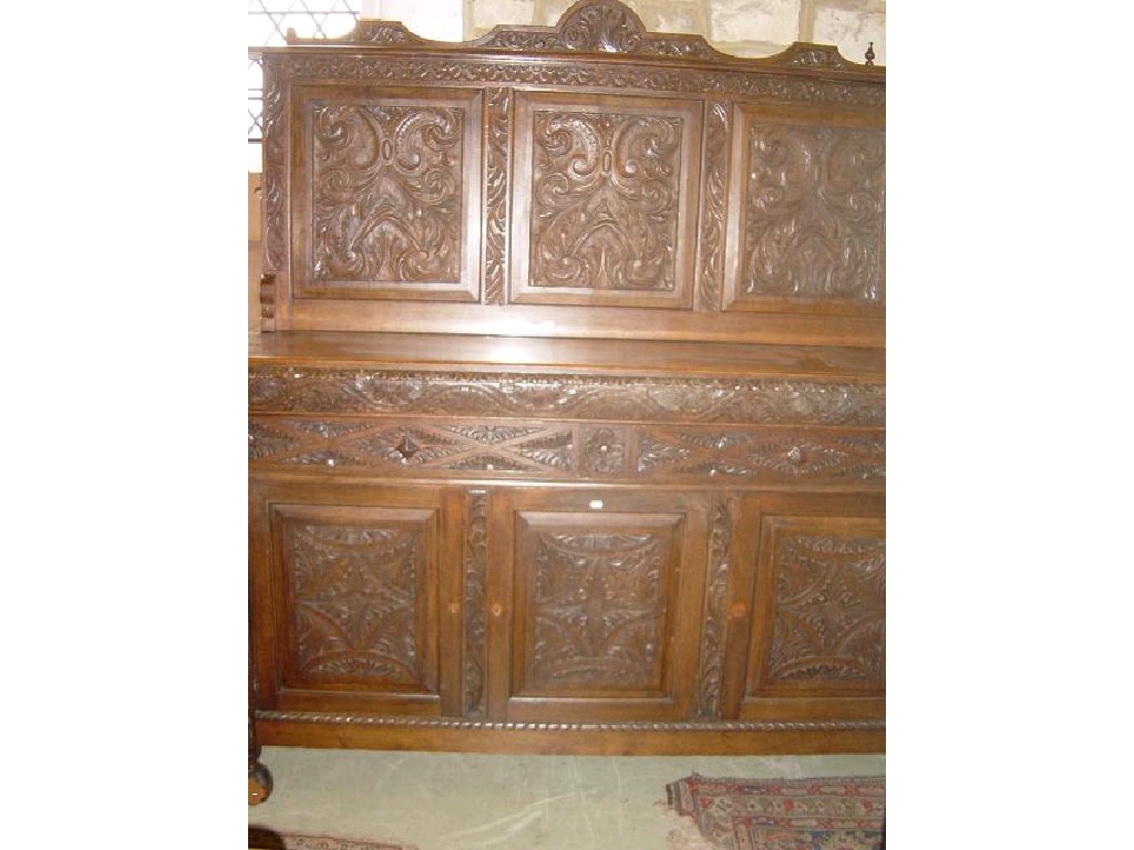 Appraisal: A substantial Victorian oak sideboard fitted with raised carved back