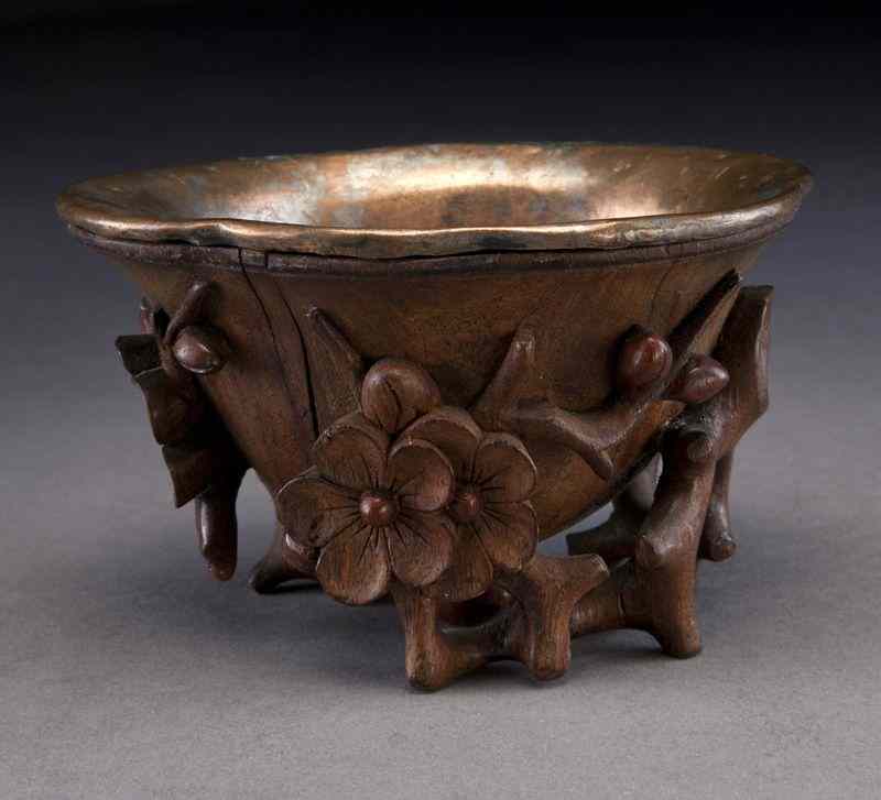 Appraisal: Chinese Qing carved huanghuali libation cupdepicting plum blossoms with a