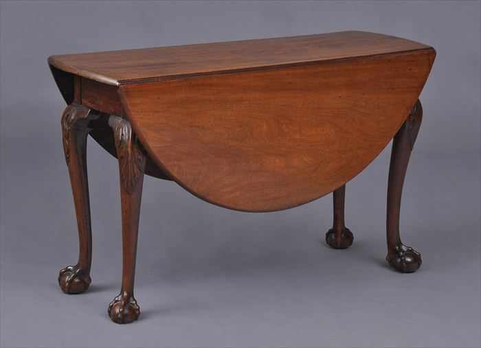 Appraisal: GEORGE II CARVED MAHOGANY DROP-LEAF TABLE The top with bowed