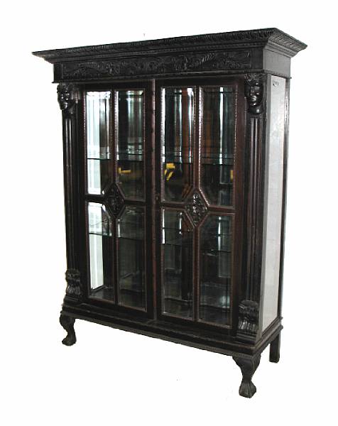 Appraisal: A Continental carved hardwood display cabinet height ft in width