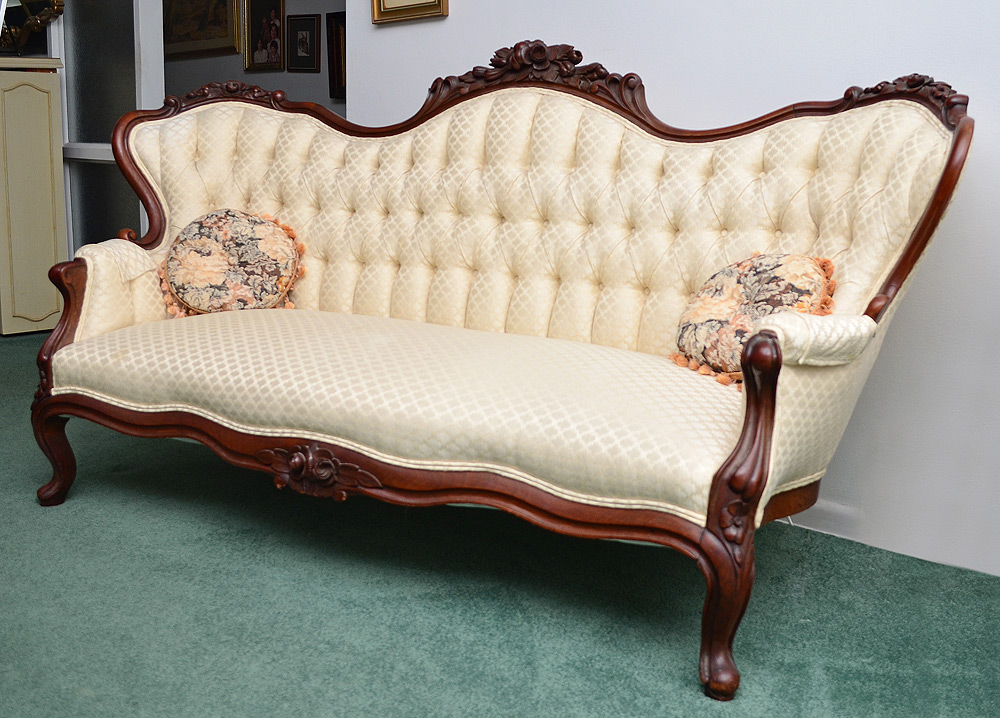 Appraisal: VICTORIAN CARVED SOFA Carved crest with floral designs shaped arms