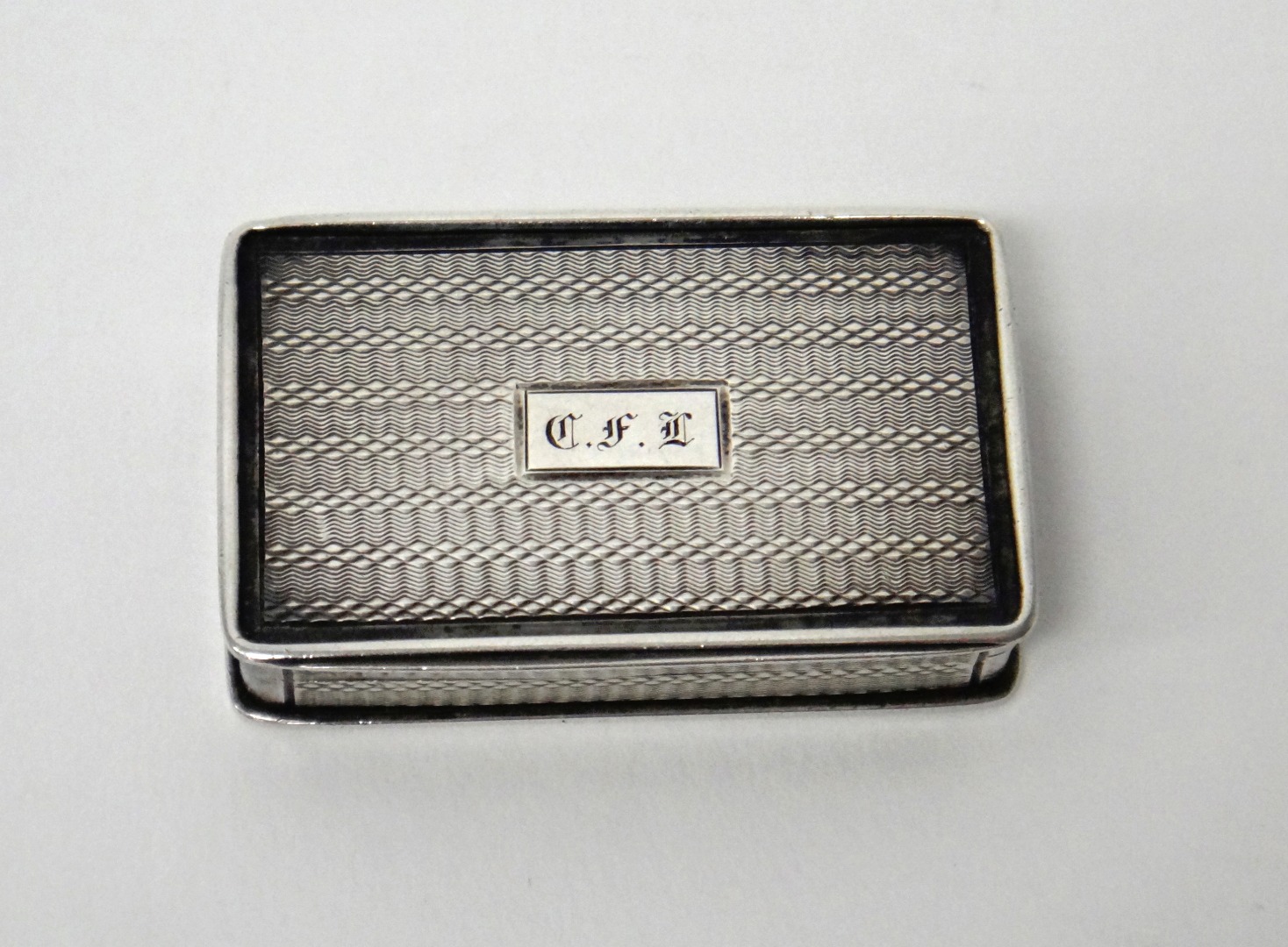 Appraisal: A William IV silver rectangular vinaigrette the exterior with engine