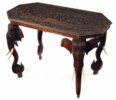 Appraisal: An Indian rosewood table the canted top carved with foliage