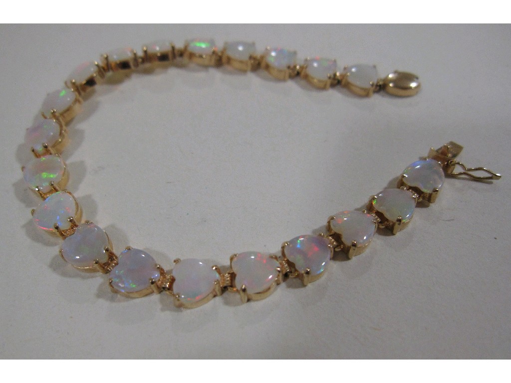 Appraisal: Fourteen carat gold mounted heart shaped opal line bracelet