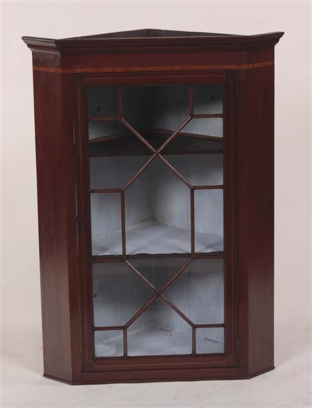 Appraisal: A th century mahogany corner cupboard the projected moulded cornice