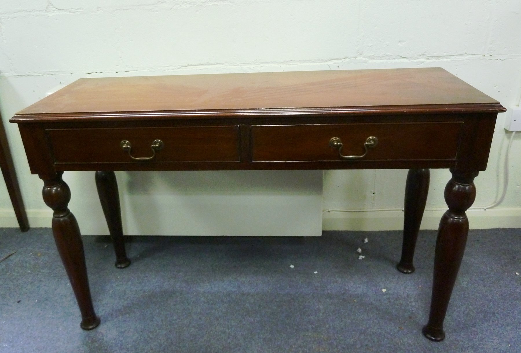 Appraisal: A mahogany two-drawer side table on turned tapering legs cm