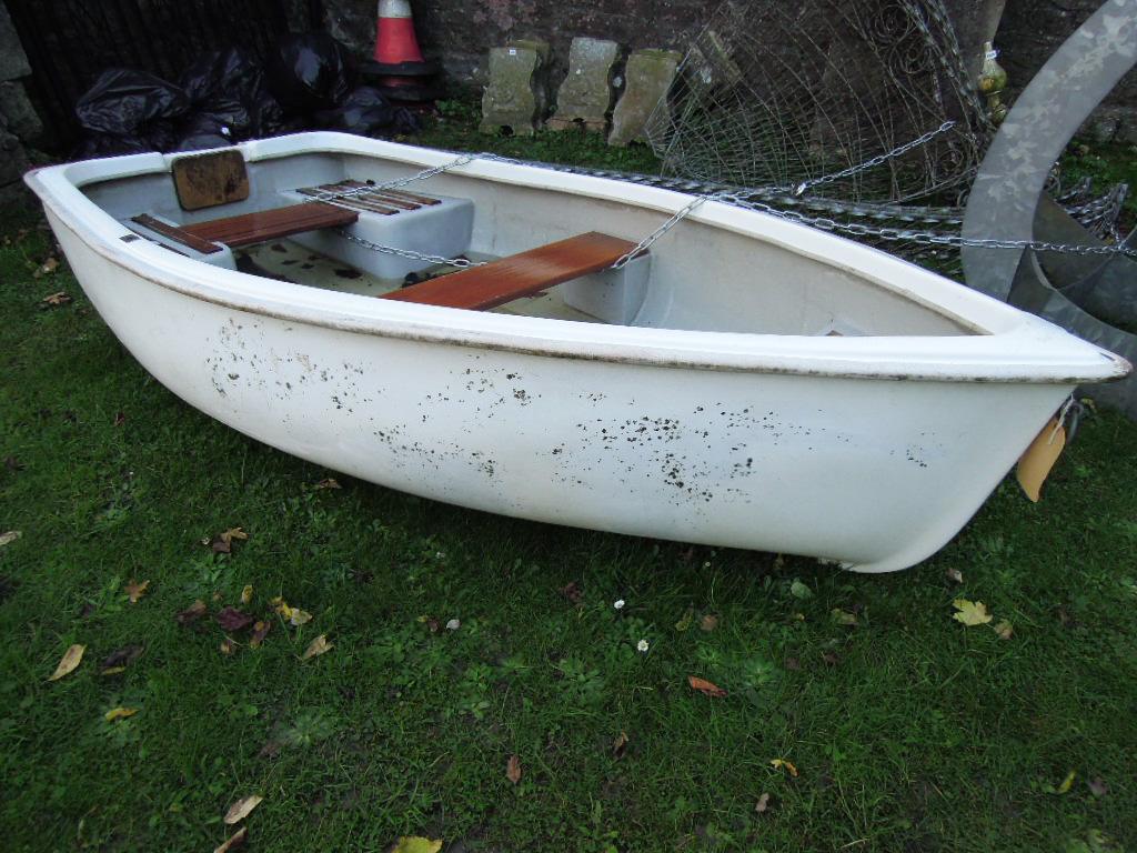 Appraisal: A moulded fibre glass and plastic rowing boat with timber