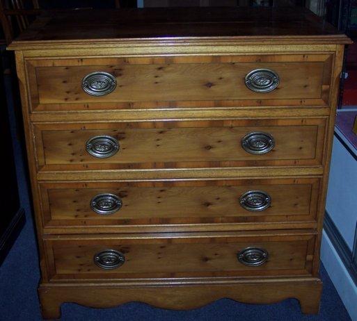 Appraisal: A yew wood chest fitted four drawers on bracket feet