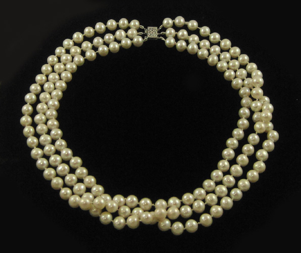 Appraisal: TRIPLE STRAND WHITE PEARL NECKLACE strung with slightly off round