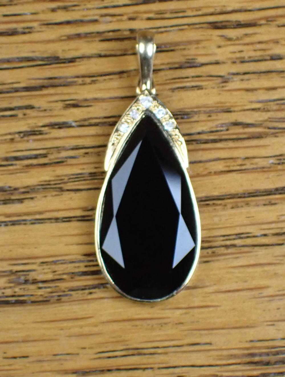 Appraisal: BLACK ONYX DIAMOND AND FOURTEEN KARAT GOLD PENDANT ENHANCER k