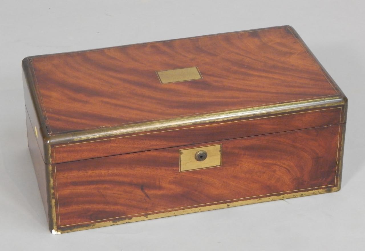 Appraisal: A thC mahogany and brass bound campaign type writing box