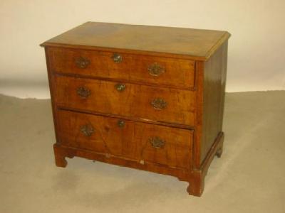 Appraisal: A WALNUT CHEST of three drawers with brass drop handles