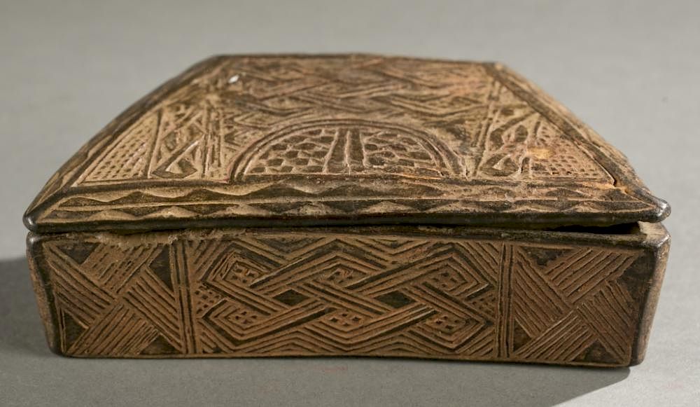 Appraisal: Kuba lidded box th c A lidded trapezoidal shaped incised