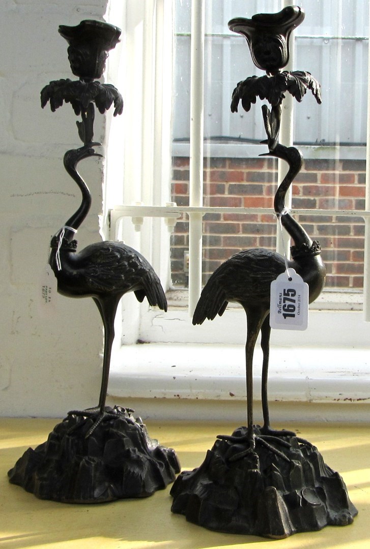 Appraisal: A pair of bronze candlesticks in the manner of Thomas