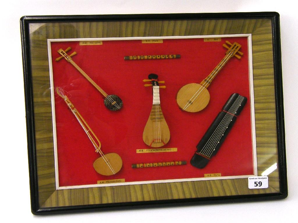 Appraisal: Seven Chinese model instruments within a framed glazed display