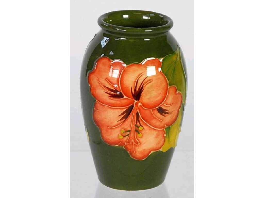 Appraisal: W MOORCROFT TUBE LINED POTTERY OVOID VASE coral Hibiscus design