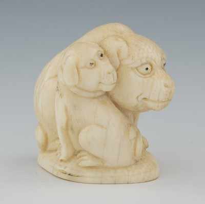 Appraisal: A Carved Ivory Netsuke of Two Dogs Depicting a seated