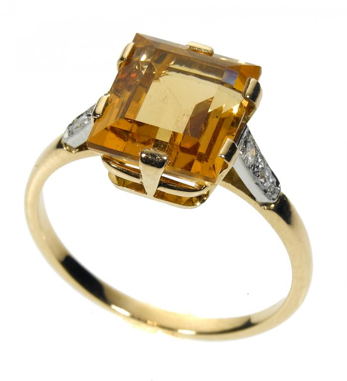 Appraisal: A TOPAZ AND DIAMOND RING the rectangular step cut topaz