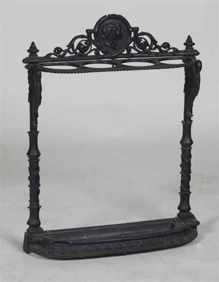 Appraisal: A cast iron stick stand the cartouche flanked by peirced