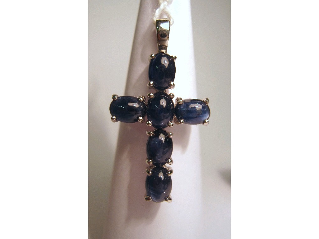 Appraisal: Nine carat white gold cabochon sapphire set cross pendant