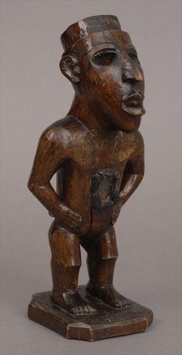 Appraisal: AFRICAN CARVED WOOD MALE FETISH FIGURE Standing with hands on