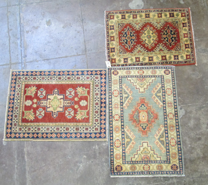 Appraisal: THREE SMALL ORIENTAL MATS Pakistani Caucasians hand knotted sizes '