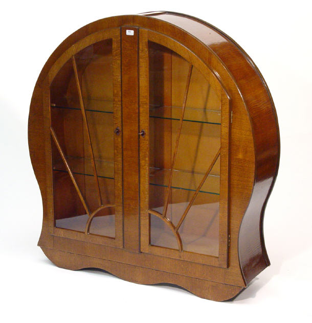 Appraisal: Art Deco oak circular bookcase fitted a pair of starburst