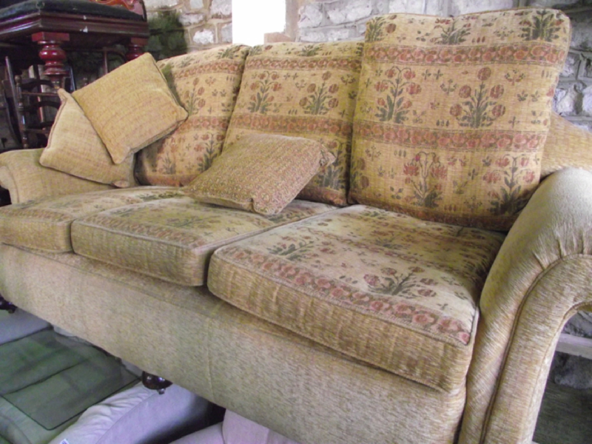 Appraisal: An Edwardian three seat sofa with scrolled arms and shaped