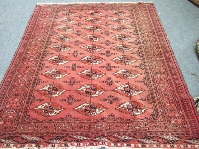 Appraisal: A Turkman rug the madder field with three columns of