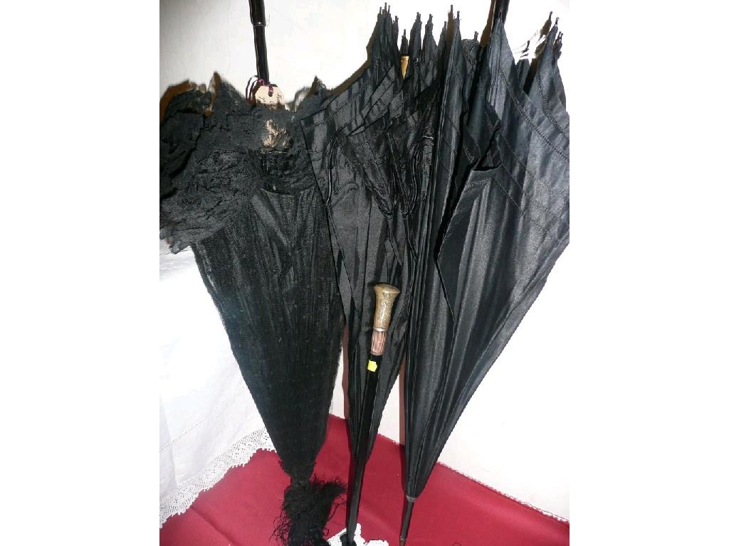 Appraisal: Three Victorian black parasols - one with a delicate carved