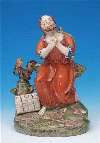 Appraisal: An early th Century pottery figure of St Peter kneeling