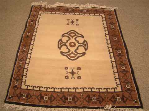 Appraisal: A WOOL ISLAMIC RUG A brown and tan wool rug