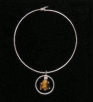 Appraisal: A Jorgen Jensen Necklace with a Tiger-eye Pendant A diameter