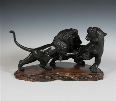 Appraisal: A Japanese bronze group of a lion attacking a tiger