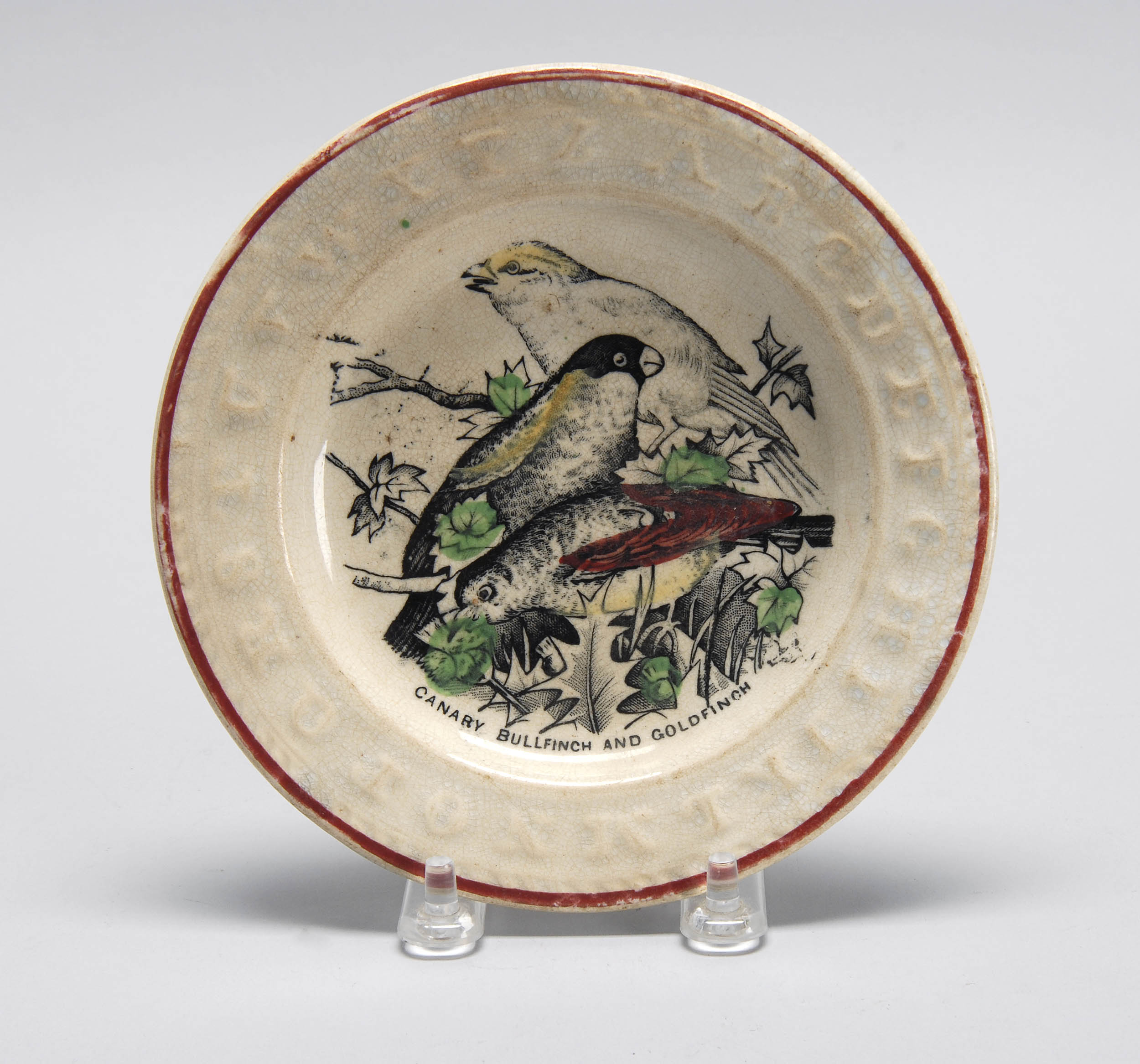 Appraisal: ENGLISH STAFFORDSHIRE ALPHABET PLATE depicting a canary a bullfinch and