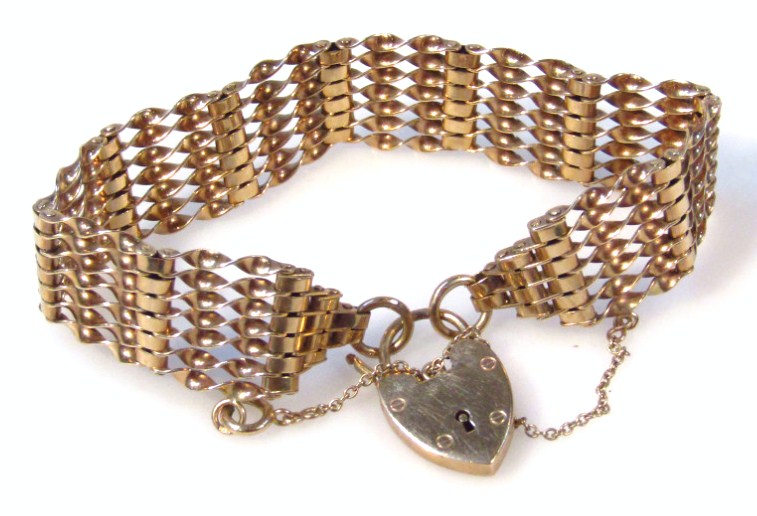 Appraisal: A gate bracelet with heart shaped clasp yellow metal marked