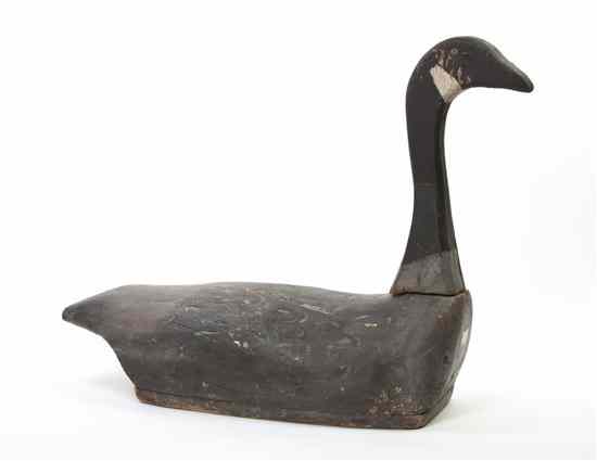 Appraisal: A Carved and Polychrome Painted Decoy depicting a swimming Canadian