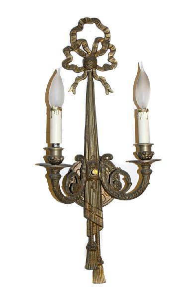 Appraisal: A pair of Neoclassical style gilt metal two light wall