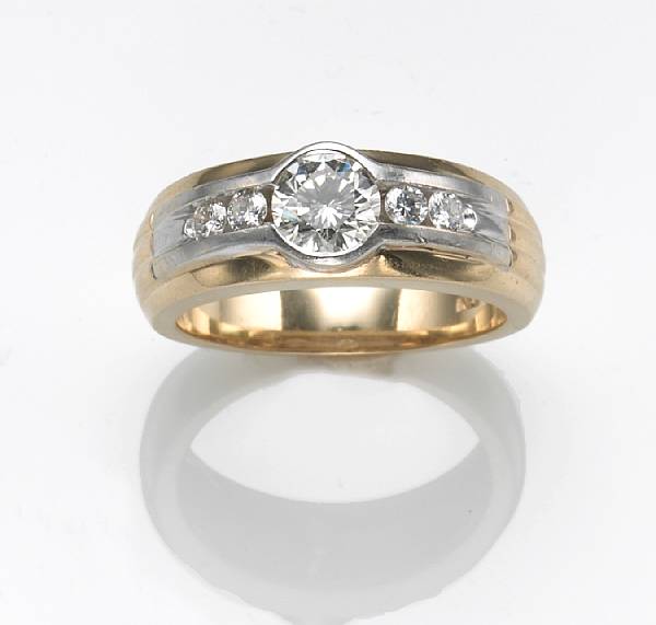 Appraisal: A diamond and k bicolor gold gent's ring center diamond