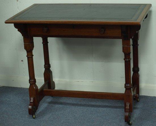 Appraisal: A walnut writing table of Gothic design stamped Gillows Lancaster