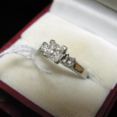 Appraisal: DIAMOND AND PLATINUM RING WITH APPRAISAL The three-diamond ring is