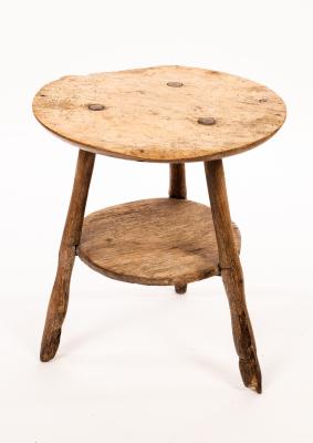 Appraisal: A rustic elm circular cricket table with platform base on